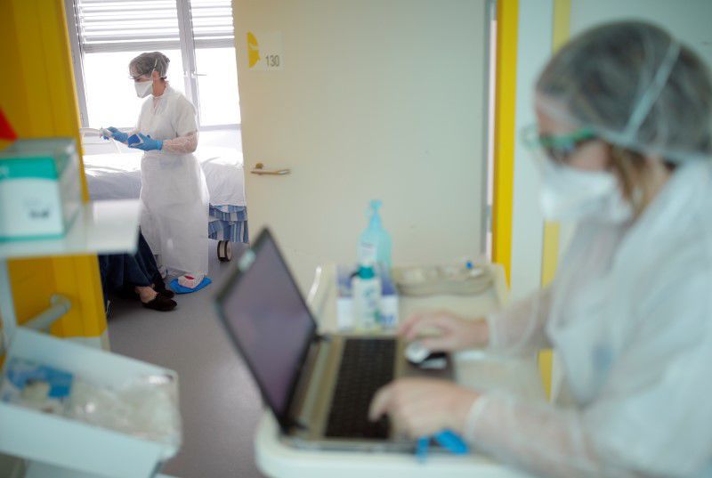 FILE PHOTO: Medical workers wearing protective masks and suits are seen at the pulmonology unit at the hospital in Vannes